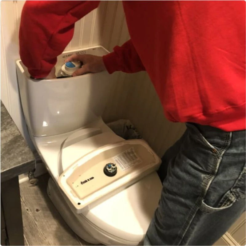 Worker fixing a toilet drain problem in Rye, NY