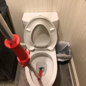 using tool to unclog a toilet
