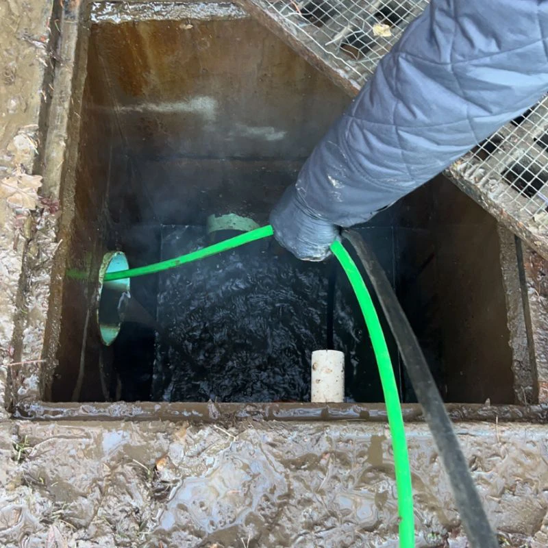 cleaning out a catch basin drain outdoors